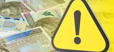 banknoty i znak ostrzegawczy